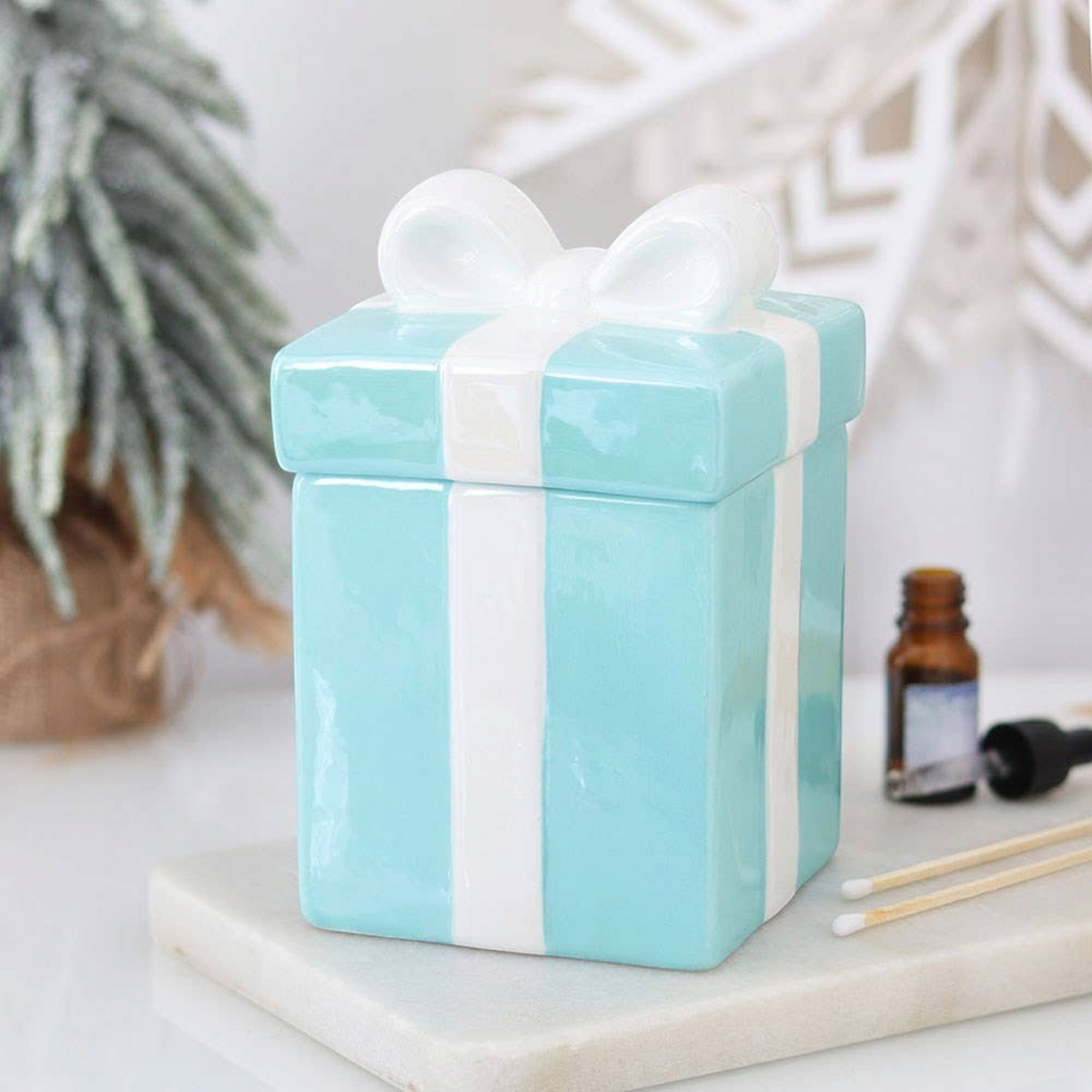 Connemara Country blue ceramic Christmas present oil burner with a white bow lid for festive home fragrance