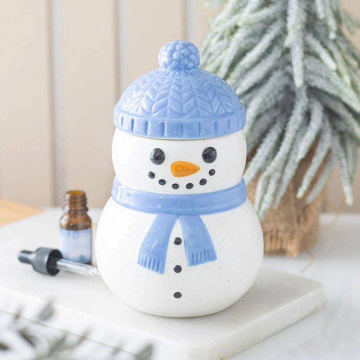 Connemara Country ceramic snowman oil burner with a blue hat and scarf, perfect for festive winter home decor.