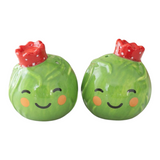 Connemara Country ceramic Brussels sprout salt and pepper shakers with festive red crowns for Christmas table decor.