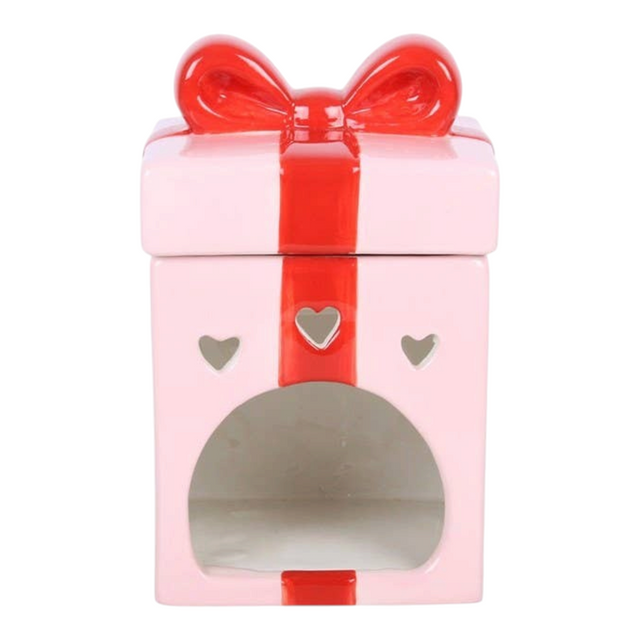 Connemara Country pink ceramic Christmas present oil burner with a red bow and heart-shaped cutouts.