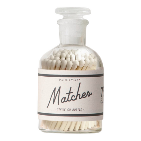 Connemara Country Paddywax safety matches with white tips in a clear glass bottle with an integrated strike strip.