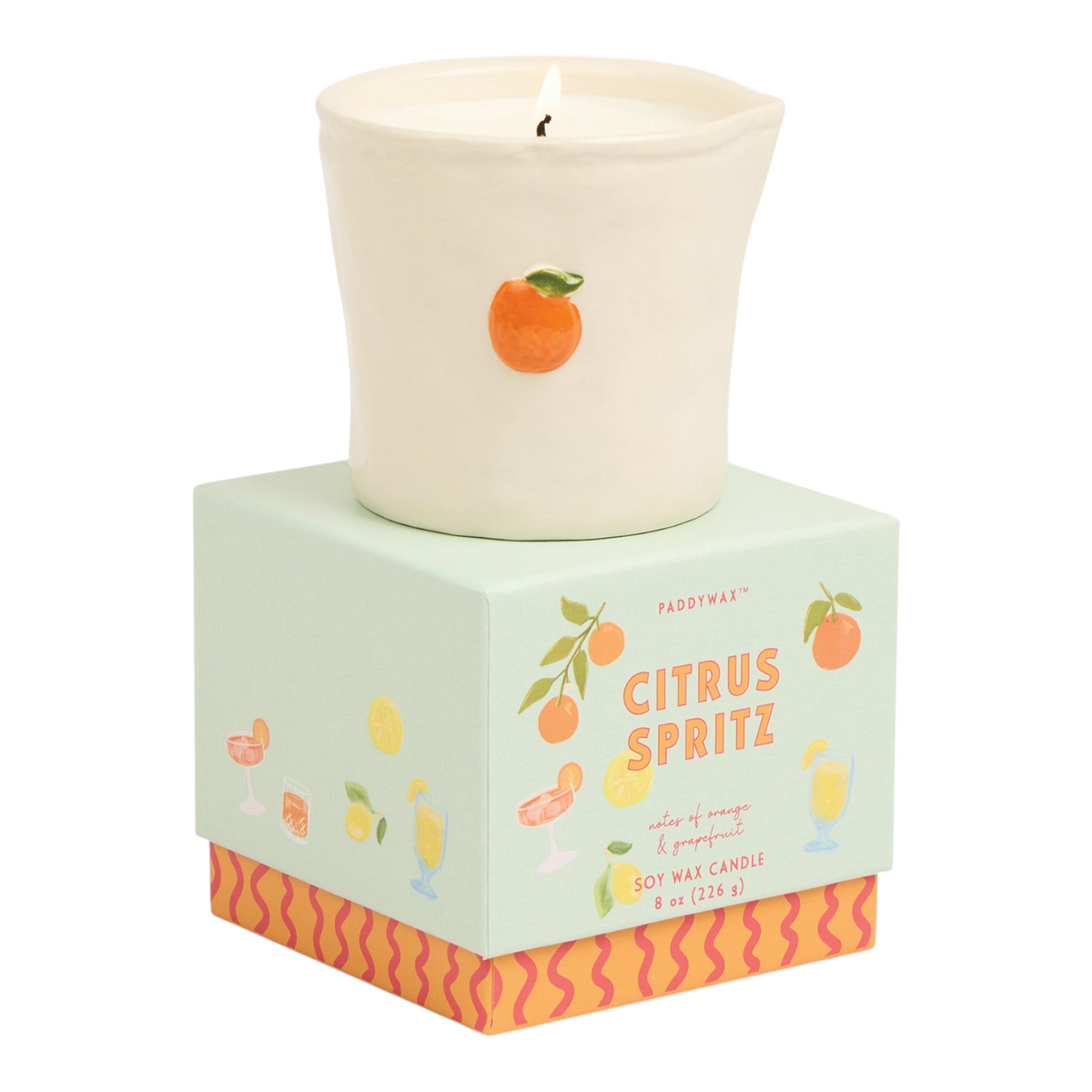 Connemara Country Paddywax Citrus Spritz candle in a cream ceramic vessel with a hand-painted orange design.