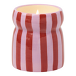 Connemara Country Paddywax Cabana ceramic candle with red and pink vertical stripes and a lit wick