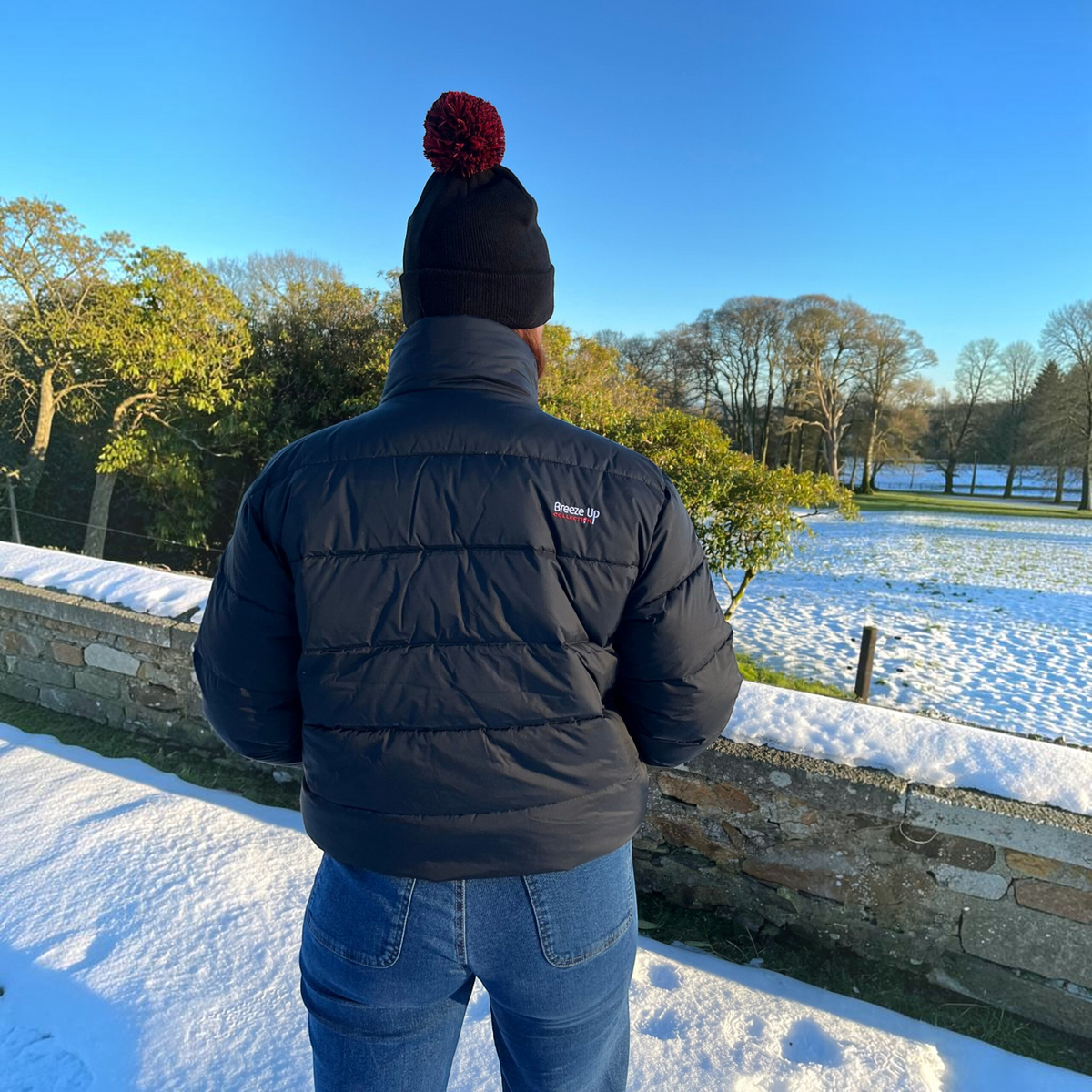 Connemara Country Breeze Up POLAR+ black goose down puffer coat worn by a person in a snowy outdoor setting