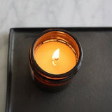 Connemara Country Billow Amber Candle with lavender and eucalyptus scent, burning with a warm glow in amber glass.