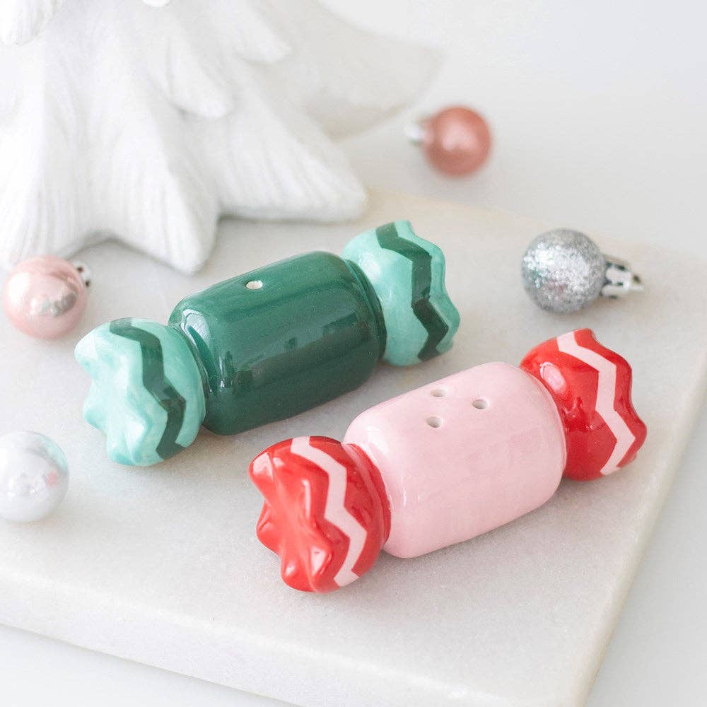 Connemara Country ceramic Christmas sweet-shaped salt and pepper shakers in green and pink on a marble surface.