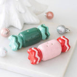 Connemara Country ceramic Christmas sweet-shaped salt and pepper shakers in green and pink on a marble surface.