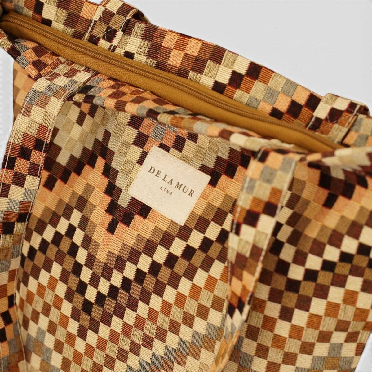Connemara Country De La Mur small tote bag in brown and beige geometric jacquard fabric with a top zipper closure.