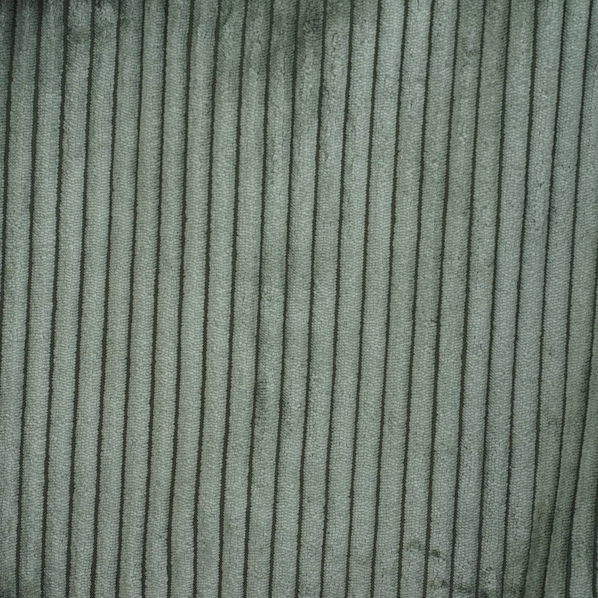 Close-up of Connemara Country moss green wide-wale corduroy fabric with vertical textured ridges
