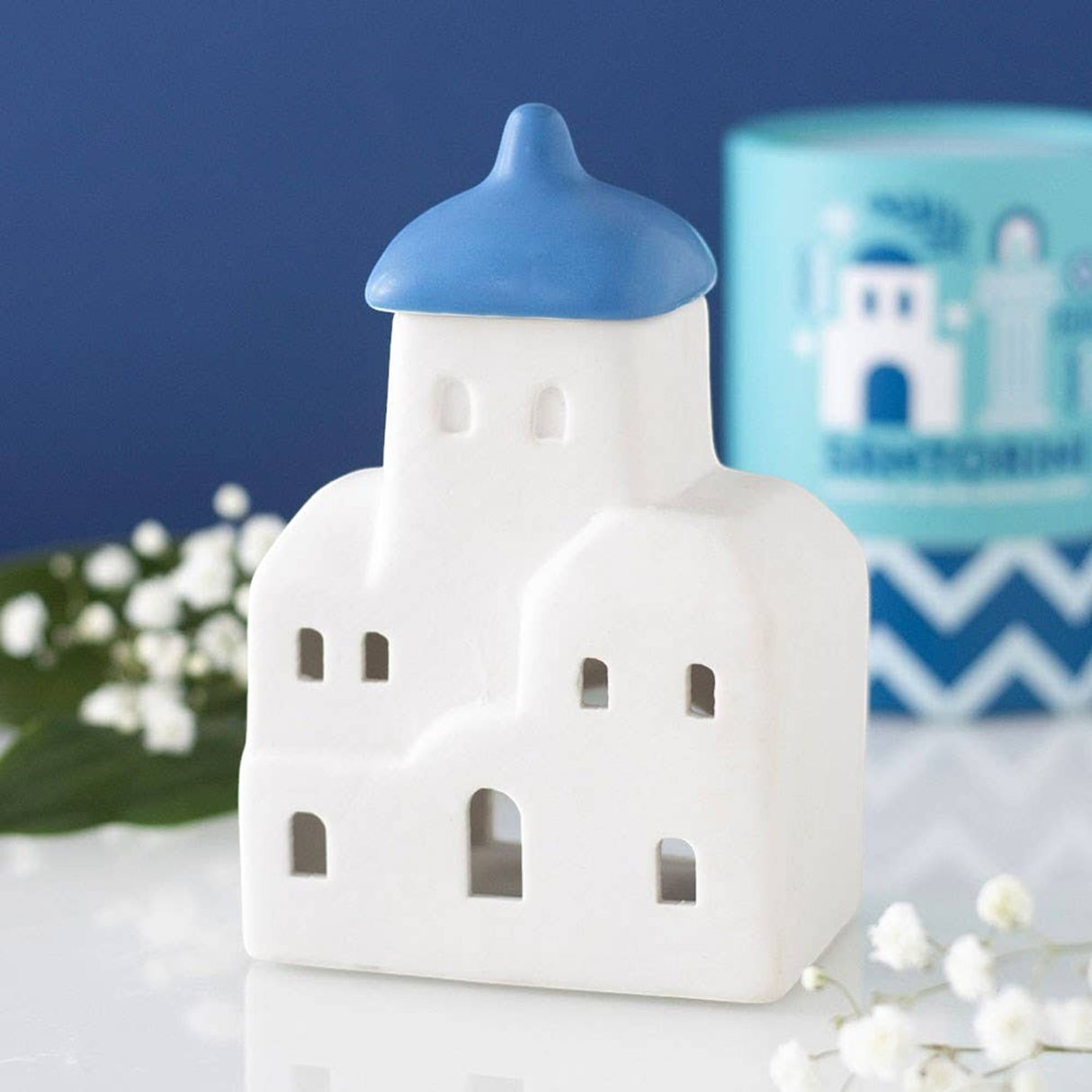 Connemara Country Santorini-themed ceramic oil burner and wax warmer with a white building and blue dome.