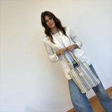 Connemara Country De La Mur small tote bag in blue and cream striped half-panama fabric worn by a woman