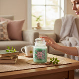 Connemara Country large glass jar candle in Tropical Bloom scent, a pale green paraffin wax candle with a decorative label.