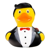 Connemara Country rubber duck groom wearing a black suit, white shirt, red bow tie, and holding a red rose.